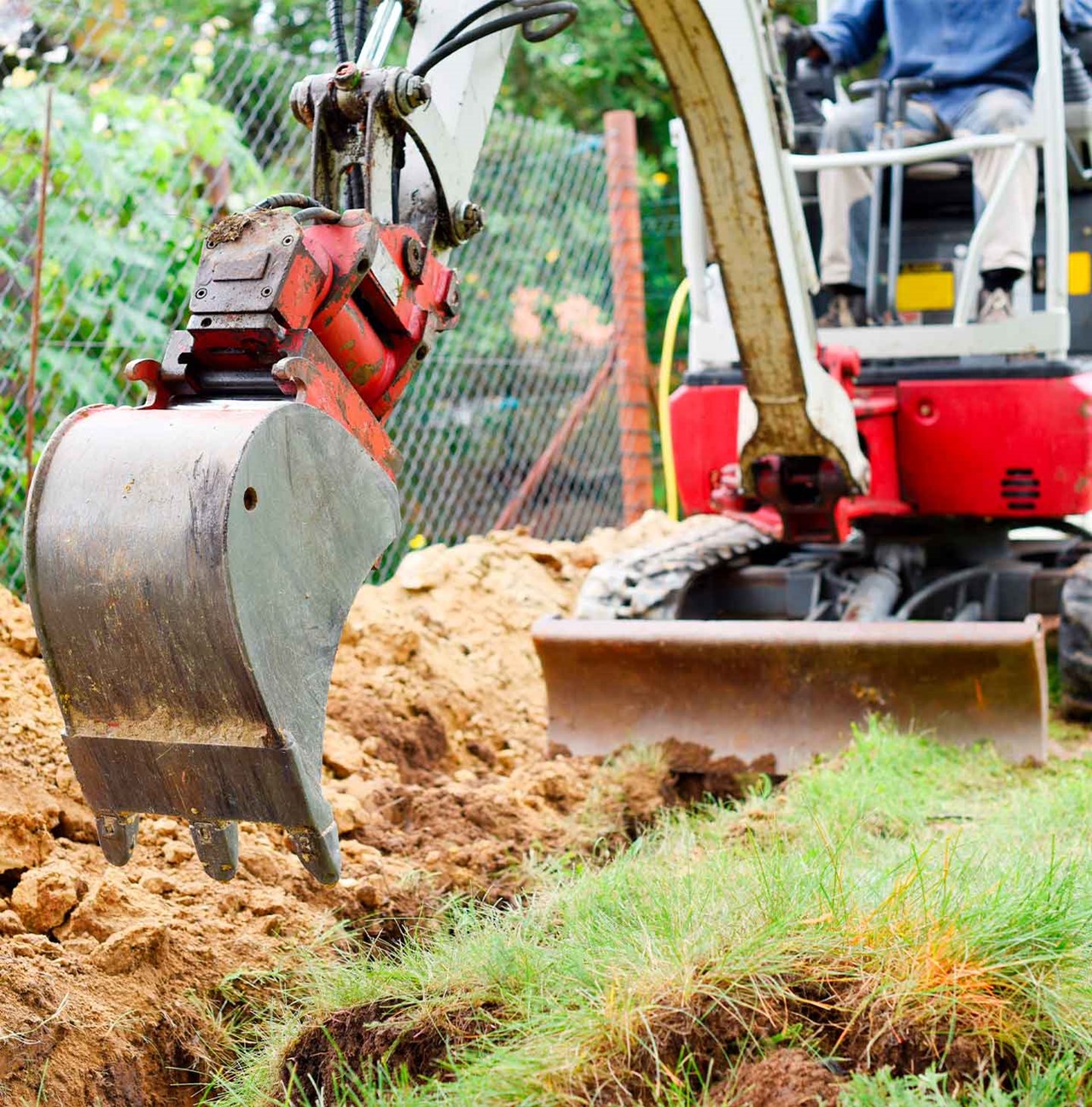 Excavatrice à batterie sur un projet de terrassement résidentiel. 